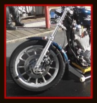 Motorcycle with it's wheel positioned for detailing by Fifty Dollar Detail.